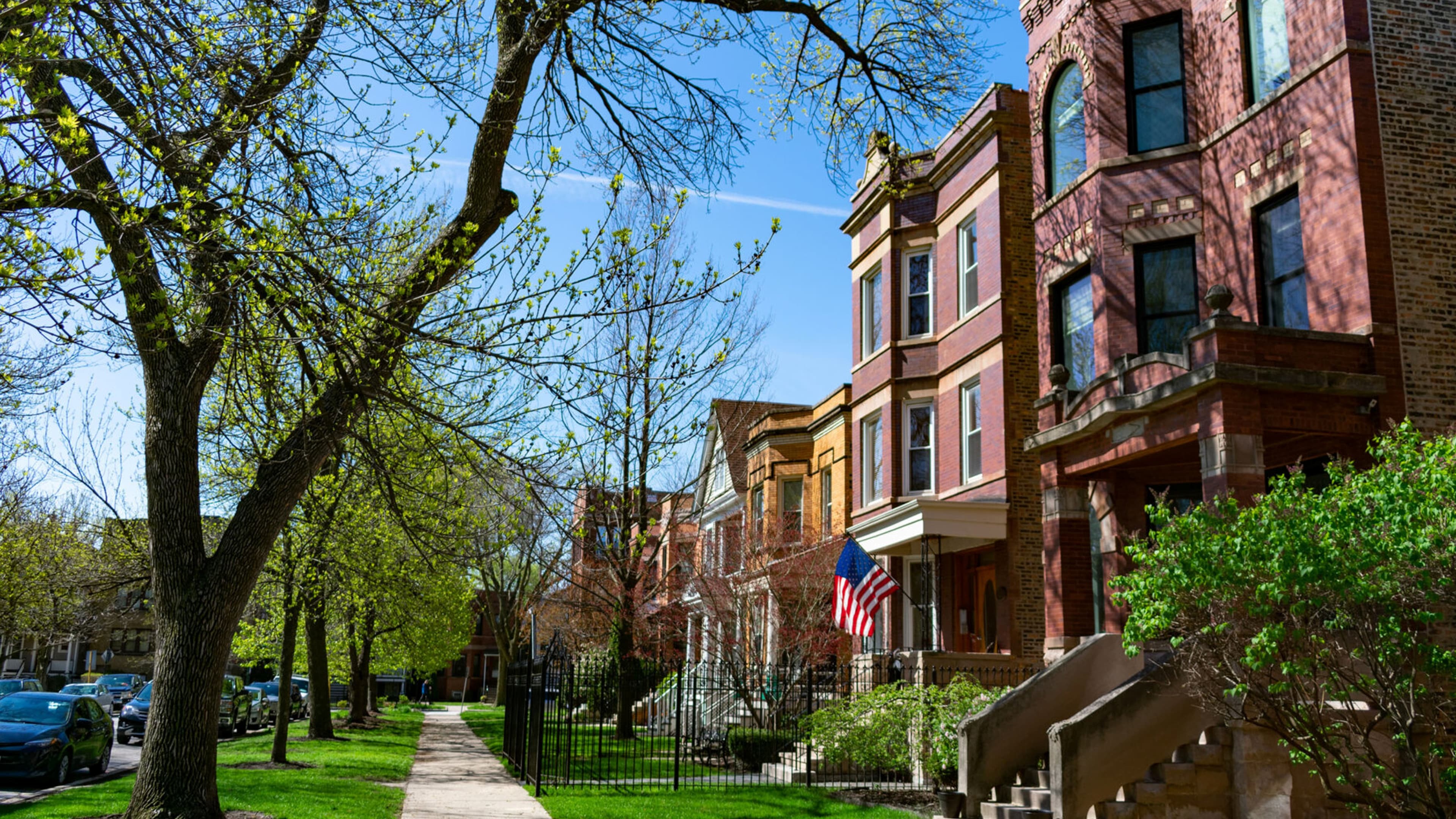 Tree-lined street with classic brick townhomes